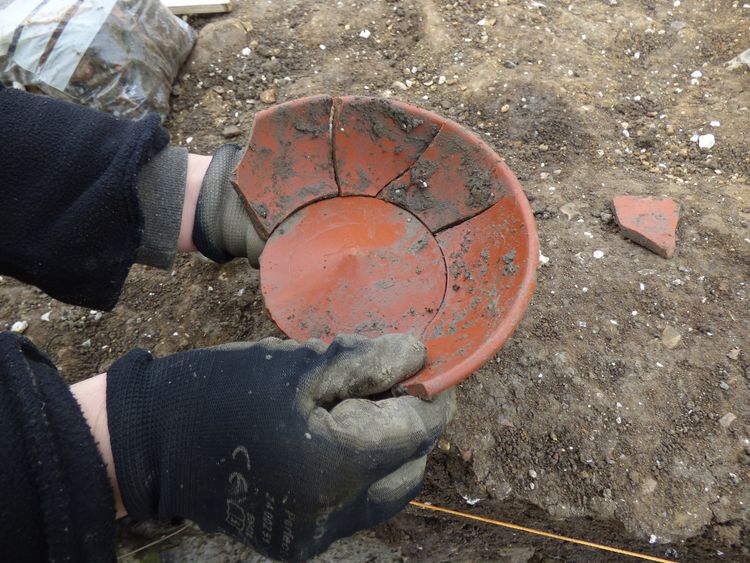 an image of some broken red ware pottery